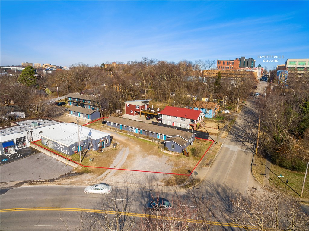 Currently a multi-use property that offers a commercial building with two separate spaces, an additional  building that has 2 one-bedroom apartments, 1 studio apartment and 3 multi-purpose commercial spaces. Property is located 2 blocks from the Fayetteville Historic Square. This prime location is within walking distance to the arts corridor, the Fayetteville Public Library, Dickson Street, U of A bus routes, and many of Fayetteville's most beloved restaurants, coffee shops, and art galleries. Zoned Downtown General, can be used for commercial retail space and in a hotel zone. The possibilities are vast and location could not be better.