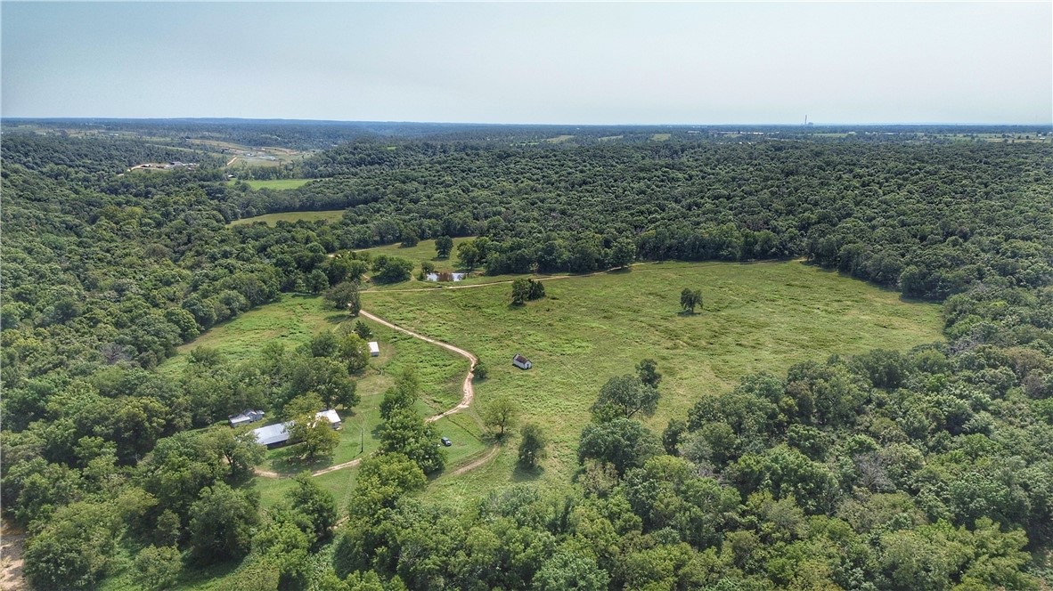 Welcome to the Allen Family Farm – a one-of-a-kind legacy property with a rich 100+ year history. This remarkable Northwest Arkansas farm for sale features rolling pastureland, mature hardwoods, and abundant natural water sources, making it a dream property for ranching, hunting, recreation, or establishing your own private estate.
The highlight of this farm is the spring-fed Coon Creek, which winds through the property and provides year-round live water while enhancing the land’s natural beauty and character. Multiple natural springs bubble up across the acreage, adding to its value and uniqueness, while a pond offers an additional reliable water source for livestock or horses.
Beyond the water, the property offers elevation changes with ridge-top views and several prime building sites overlooking the countryside. Established trails meander through the land, ideal for horseback riding, hiking, or mountain biking, making this farm jus as much a recreational paradise. 
Sale is subject to court approval.