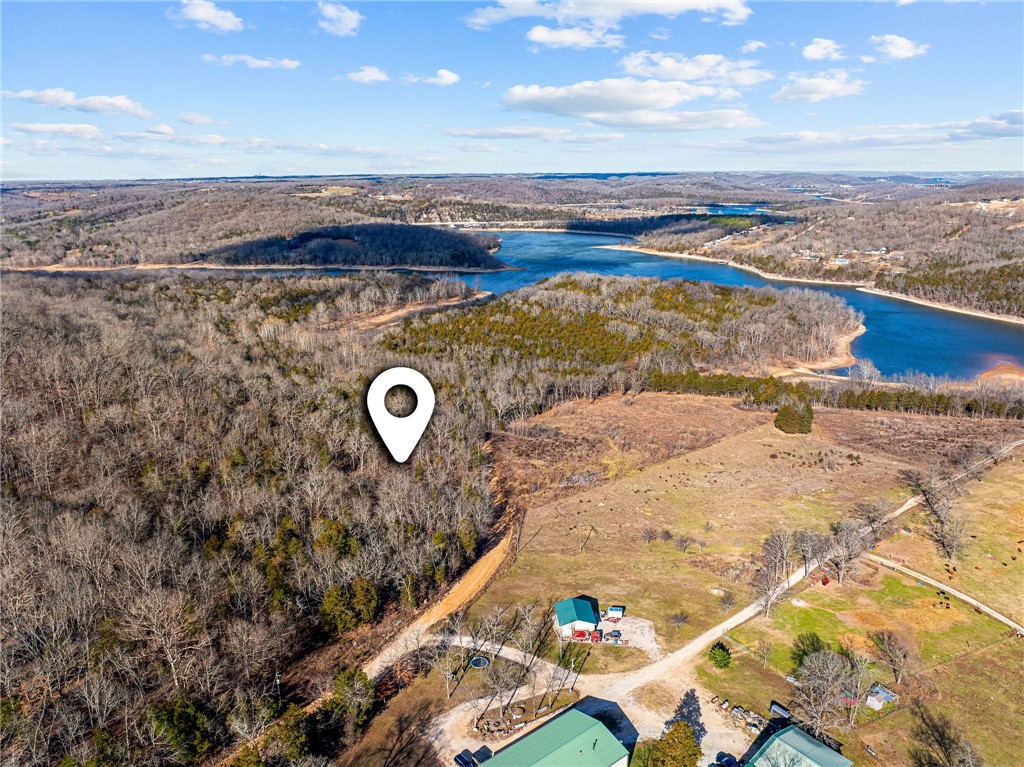 WHAT A VIEW!!  Beautiful 6-acre vacant land parcel in Omaha, AR offering stunning lake views and sweeping panoramic scenery. This unrestricted property provides the freedom to build your dream home, vacation retreat, or STR investment property with no HOA or restrictions. Electricity available at Enon Rd! Enjoy peaceful surroundings with easy access to Highway 65 and a convenient location just 15 minutes from Cricket Creek Marina, Big Cedar Lodge, Top of the Rock, and Thunder Ridge Nature Arena, and only 25 minutes to Branson. An optional 12 x 30 boat slip is available for an additional cost and is located in a 3-year-old dock featuring durable concrete decking—perfect for enjoying lake life and outdoor recreation. Rare opportunity to own scenic acreage with flexibility and accessibility—don't miss it.