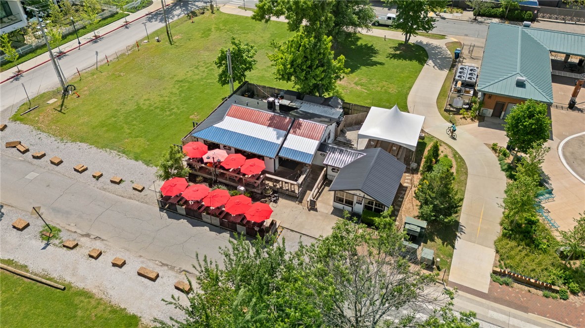 LOCATION. LIFESTYLE. LEGACY ASSET.
Exceptional investment opportunity in the heart of downtown Bentonville—one of the fastest-growing and most sought-after areas in the state. Located directly across from the world-renowned Slaughter Pen Trailhead and at the gateway to the All-American bike trail system, this prime commercial property offers outstanding visibility and consistent traffic. Just a short walk to the vibrant downtown square, top-tier dining, shopping, and cultural attractions, this property truly sits at the crossroads of lifestyle and commerce. Surrounded by rapid development and rising property values, opportunities like this are becoming increasingly rare. The property features an existing tenant in place, providing immediate, stable income. Business is not for sale—please do not disturb tenant. Seller is offering a rare opportunity to OWNER FINANCE this exceptional downtown asset, creating a flexible path to secure a premier piece of real estate in a high-demand, high-growth corridor.