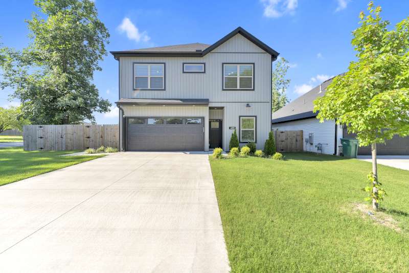 Fall in love with this beautiful Northwest Arkansas gem! Tucked away on a spacious, level corner lot with absolutely NO HOA, 488 W 2nd St offers space, style, and an unbeatable location. Commuting is a breeze with the Walmart Home Office and downtown Bentonville just 10 minutes away. The split-bedroom floor plan centers around a light-filled living area boasting dramatic vaulted beam ceilings and a cozy electric fireplace. Work from home seamlessly in the private office, or entertain in the gourmet kitchen outfitted with quartz countertops and a massive pantry. With 4 bedrooms and 3.5 baths—including a versatile upstairs bonus room with a private full bath—there is plenty of space for everyone. Step outside to a fully fenced backyard ready for pets and play. Walk to nearby city parks or enjoy a short drive to top-tier Bentonville schools. Blinds, gutters, and a full privacy fence are already done for you—just unpack and move right in!
