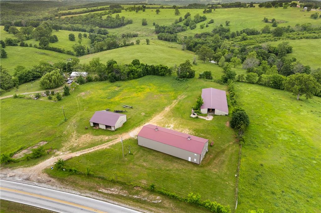 Just 5 minutes from Bull Shoals Lake, this versatile 5-acre property offers an incredible opportunity to create your own lake home or private getaway. The centerpiece of the property is an approx. 100’ x 40’ heated and cooled shop building with electric, water, and sewer already in place. With 16-foot sidewalls, three 14-foot-tall doors, a 10k lb. car lift, and existing bathrooms, the space offers the potential to add bedrooms and convert into living quarters, making it ideal for a custom lake retreat, barndominium-style home, or guest space.  
The property also includes two additional buildings (50' x 40' & 112' x 55'), perfect for storage, lake toys, or future use. The level, usable acreage provides an excellent spot to build another home or cabin while still maintaining privacy and room to roam. Whether you’re dreaming of a full-time residence, a weekend lake escape, or a family retreat, this property delivers space, flexibility, and a prime location near Bull Shoals Lake. Also listed w/house MLS#1346851.