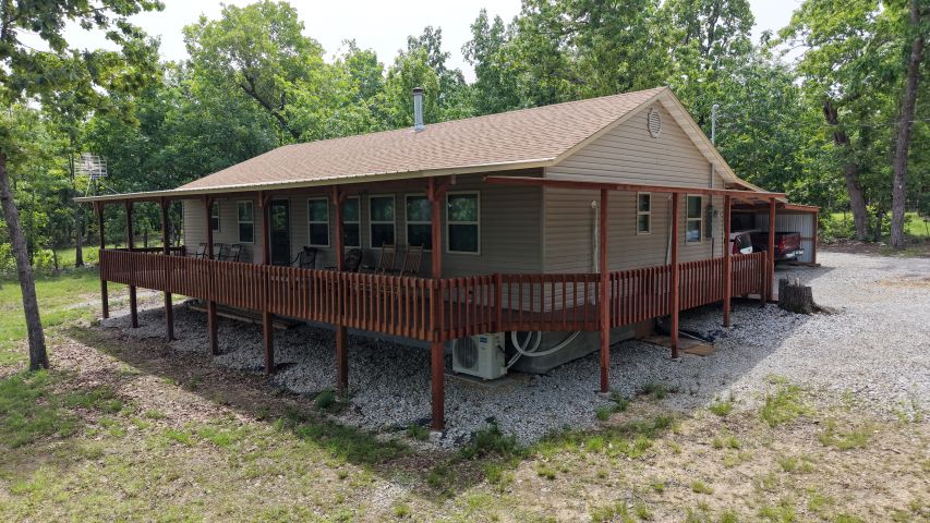 Tucked away in the beautiful Ozarks near Bull Shoals Lake, this charming 2 bedroom, 1.5 bath cabin offers the perfect blend of privacy, recreation, and country living on 6.6 acres. Surrounded by mature trees and peaceful scenery, this property is ideal as a full-time residence, weekend getaway, or vacation rental opportunity. The cozy cabin features comfortable living spaces, plenty of natural light and incredible views on the wrap-around covered deck. Outside, you’ll find a large 20 x 40 shop/garage combo with ample room for vehicles, boats, tools, and workshop space. With plenty of acreage to explore and easy access to world-class fishing, boating, and outdoor recreation, this Ozarks retreat is ready for you to enjoy. Experience the quiet beauty of Arkansas living just minutes from the lake! Call for showing today!!! This one won’t last long.