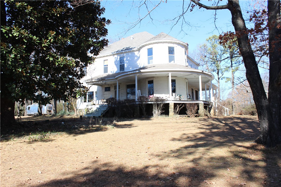 This property has been in the same family since the early 1930's, over 80 years.  The house was once a grand home, including a curved porch facing the amazing view to the east and south.  It has always been occupied but needs much restoration work.  The main value is in this incredible tract of land.  The entire frontage along Haskell is level and once grazed horses.  There is a fairly steep slope to the south &  east that affords gorgeous views of the UofA, including Old Main, & the Ozark Mountains.