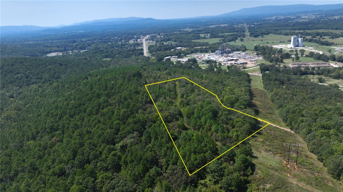 11.58 acres located within the city limits of Danville with an existing east–west road running through the property, providing immediate access and a strong framework for subdivision or estate-style development.
The land slopes gently from west to east, creating elevated homesites with views over Danville and the Petit Jean River. Well-drained topography supports efficient site planning and construction.
Utilities available include power, fiber, telephone, and a 12-inch water line, with public sewer nearby. Paved road frontage, reliable cell service, and city services in place.
Bordered by Ouachita National Forest to the south and city-owned land to the east, offering privacy, natural surroundings, and long-term protection from future development on adjoining tracts.