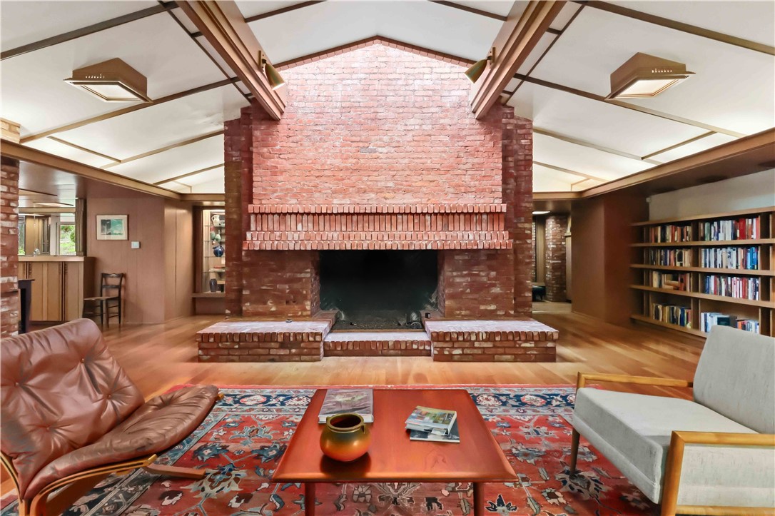 This architecturally significant residence is more than a home—it is a piece of Arkansas design history and a rare opportunity to own a true work E. Fay Jones masterpiece tucked into the wooded hillside of historic Mount Sequoyah. Originally designed in 1963 as the Glenn & Helen Clark House. Native stone, soaring cathedral ceilings, dramatic geometric detailing, expansive walls of glass, and rich wood elements create a timeless architectural experience filled with natural light and treed views from nearly every room. Situated on approximately .74 acres, this 3-bedroom, 3.5-bath residence offers 2780 square feet of thoughtfully designed living space with multiple living areas, striking fireplaces, built-ins, skylights, and exceptional craftsmanship throughout. The gardens enhance the home’s peaceful, secluded setting while remaining minutes from downtown Fayetteville, the University of Arkansas, parks, schools, shopping, and medical facilities. Even better: 797 s.f. garage with half bath and industrial sized doors!