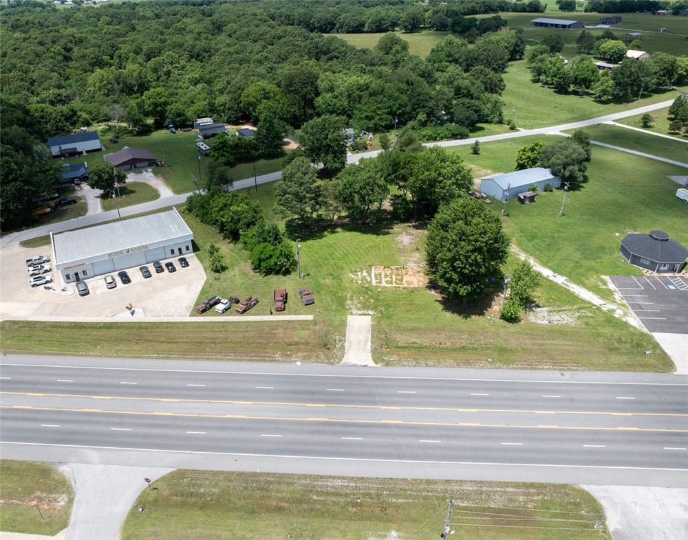 Unique investment and development opportunity featuring two adjoining parcels totaling approximately 1.15 acres. The property includes one commercial parcel and one residential parcel, offering flexibility for a variety of potential uses.  The residential zoned parcel is pending with the city of Prairie Grove for commercial rezoning.  Located on a busy 4-lane highway with excellent visibility and traffic exposure, the property is just 3 miles from Prairie Grove, 3 miles from Farmington, and only 6.5 miles from Interstate 49. Convenient access, strong frontage, and a highly desirable Northwest Arkansas location make this an exceptional opportunity for investors, business owners, or developers. Agent owned