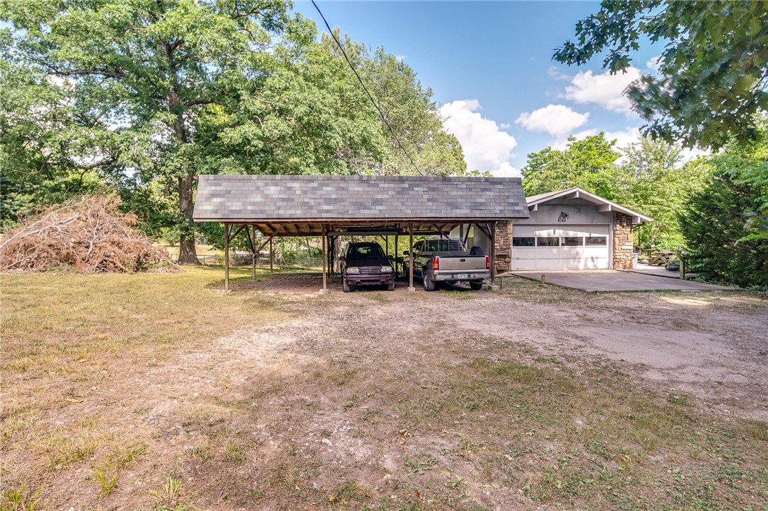 4 lots! Just a couple minutes from the lake. Come see this beautiful home near Beaver Lake. Spend time & enjoy the view in the spacious sunroom. Kitchen has quartz counters, tiled backsplash, & plenty of cabinet space. 2 wood-burning fireplaces. Master on main level. Fully screened in porch downstairs with carpet. Spend time out on any of the 3 decks or have fun in the large yard. Large storage shed conveys. Laundry room is downstairs. Roof replaced in 2017. Water heater in 2018. This won't last long!