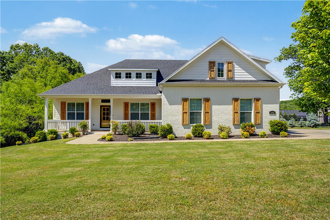 Beautifully maintained single-family residence, constructed in 2019, that offers a refined living experience. This attractive bungalow-style home, situated on a generous size lot, presents an exceptional opportunity for those seeking both comfort and sophistication. The heart of this home is its open-plan kitchen, seamlessly integrating with the living room. Here, culinary enthusiasts will appreciate the high-end range, stainless steel appliances, and elegant stone counters. A central island, thoughtfully equipped with a sink, provides both prep space and a natural gathering point. Adjacent to this, the living room offers a welcoming ambiance, centered around a cozy fireplace. Retreat to a bedroom designed for comfort, featuring a soaring cathedral ceiling that enhances the sense of space. Another bedroom offers a high ceiling, adding to its open and airy feel, while a third boasts a vaulted ceiling and rich hardwood flooring.