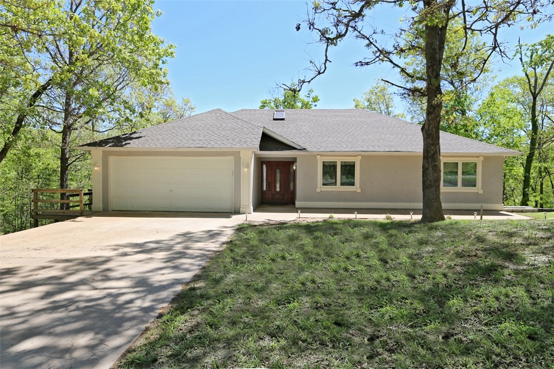 Cozy home close to Bentonville on secluded lot. New roof! Sun room and deck overlooking timberland.  Radiant heated floors throughout.  The 1000 sq. ft. unfinished basement with separate driveway would make a perfect guest apartment.