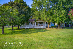 This updated charming 4 bedroom home has recently been updated inside and out! Enjoy a slice of pure country living in this serene setting but LESS than 10 minutes from town. Home is on almost an acre lot.  Privacy fence around the backyard makes this country setting feel secluded. Seller has updated all windows at a cost of $17,000.  Windows USA contains a lifetime transferable warranty.  The property also includes a second septic and water spigot on the edge of the property for a camper to be hooked up.