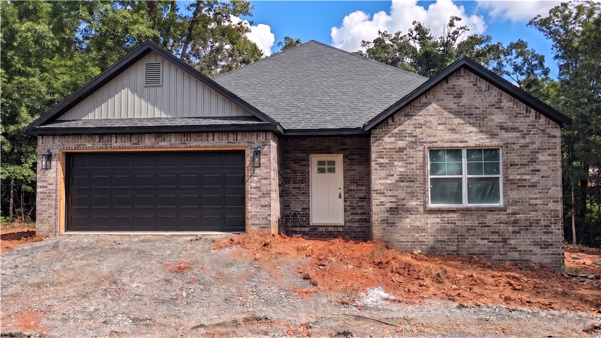 Welcome to your brand-new construction sanctuary nestled in the serene woods of Bella Vista! Situated on a generous, private lot of nearly half an acre, this gorgeous home perfectly blends modern craftsmanship with a peaceful, natural backdrop. The front of this home boasts a striking, durable full-brick facade and an inviting two-car garage. Step around to the back and you'll find low-maintenance horizontal vinyl siding and a charming wood deck—ideal for morning coffee or evening relaxation while taking in your wooded views. Located in the highly sought-after Pea Ridge School District, this property offers the ultimate combination of pristine, new-build efficiency and Northwest Arkansas's famous outdoor lifestyle. Don't miss the chance to make this beautiful new build your home!