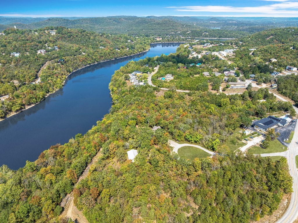 Don't miss your chance to own one of the few remaining waterfront properties!! 0.48-acre lakeview lot offers stunning views of Table Rock Lake. Located nearby are amenities such as a marina, fishing dock, recreation center, swimming pool, park, tennis courts, 2 golf courses, country club and more!! The land is mostly level near the road, then gently sloping towards the lake, providing an excellent building site that captures the beauty of the surrounding landscape and lake. It is lightly wooded with mature trees, offering privacy and a serene, natural setting. There is plenty of space to build your custom home with room for a deck or a garden. The property is accessed via a paved road, and utilities (water, sewer, and electricity) are available on-site, making it a prime location to create your lakeside retreat.