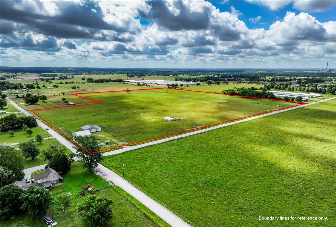 If you are looking for level land just outside of Gentry city limits with no deed restrictions, this could be the perfect location for you! Approximately 30 acres that fronts both Bloomfield North Road and Floyd Moore Road. Water, electric and propane are already on site. The main water line of Gentry runs along the front of the property. Comes with a 42 x 50 Equipment Barn with a 12 x 50 lean-to attached and a 66 x 50 Workshop on a concrete slab. The workshop has central heat, one hydraulic car lift and three 12 x 10 doors for large equipment. Propane tank is owned. A new survey is in progress. Great property for developing. Has so much potential and endless possibilities! Don't miss out!