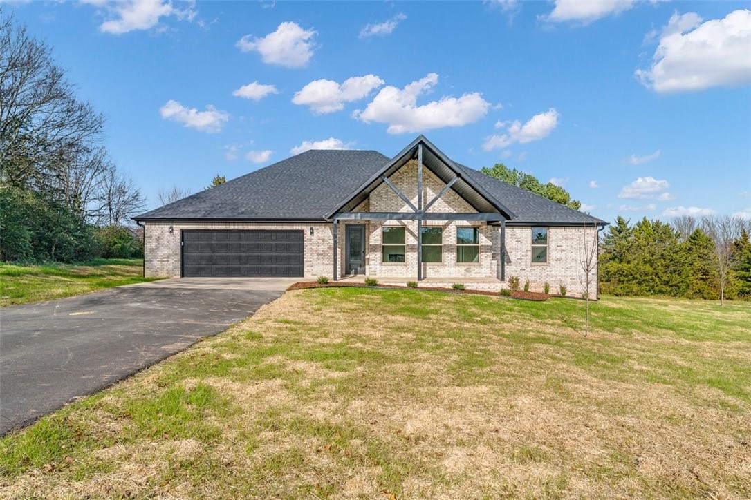Tucked away on a quiet street, close to schools & shopping is a beautiful, all brick, brand new home, just waiting to be called yours!  With a large 1.24 acre lot and 2,243 square feet, you'll find plenty of space to stretch out! A well laid out floor plan maximizes space & allows for plenty of storage with walk-in closets and nine foot ceilings.  Beautiful, easy maintenance finishes such as quartz countertops, grout free shower walls and luxury vinyl plank flooring take the worries out of maintenance and cleaning and energy efficient appliances and insulation will save energy costs.  Thoughtful details throughout make this home sparkle, such as the vaulted, wood beamed ceiling and glass front fireplace in the living room, trim details, shaker style cabinets and large amount of natural light from the many windows.  An oversized garage with epoxy painted floor allows for workbenches as well as opening car doors without worry. Seller agrees to pay up to $5,000 of buyer closing costs and prepaids at closing!