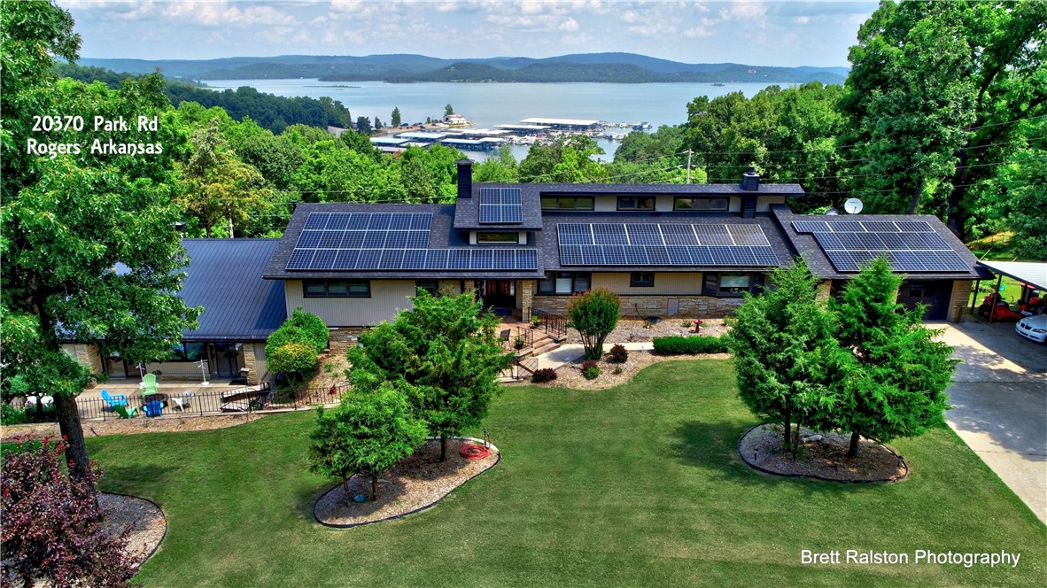 This Gorgeous 1.86 acre Estate is nestled in the heart of the popular Rocky Branch area of Beaver Lake, & provides year round breathtaking views of the Lake & all the Arkansas Ozarks have to offer. Overlooking the marina, it currently operates as a thriving vacation destination, booking for $1200 a night, and even offers private quarters on the premise for management. Sold fully furnished, & having had over $300K in renovations, this home is ready to be enjoyed.  Some features include: Solar panels, Elevator, 3 different outdoor patios/decks, newly updated bathrooms, fresh paint throughout the home, a master chef kitchen w/Jen-Air appliances, a commercial grade gas fireplace, updated lighting fixtures, & new carpet in the bedrooms- just to mention a few. With plenty of room to entertain- take advantage of your very own indoor pool, hot tub, & sauna for year round enjoyment, or maybe gather outside around the custom fire pit. Whether you are an investor, or home owner, this is the one you don't want to miss.