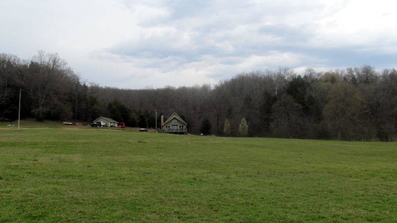 Absolutely beautiful custom home on 4 AC. 4/2 w/office PLUS add'l space on landing. Open living/kitchen/dining concept w/cathedral ceiling, plenty of large custom windows to enjoy the view! Rustic hand-hewn barn beams case the exterior doors. Marathon HWH, 2nd oven, HUGE utility room, solid oak hardwood floors. 2 tier deck piped w/propane for the grill. 20x24 shop building w/ concrete floor, wired 110/220. Attention to detail abounds!