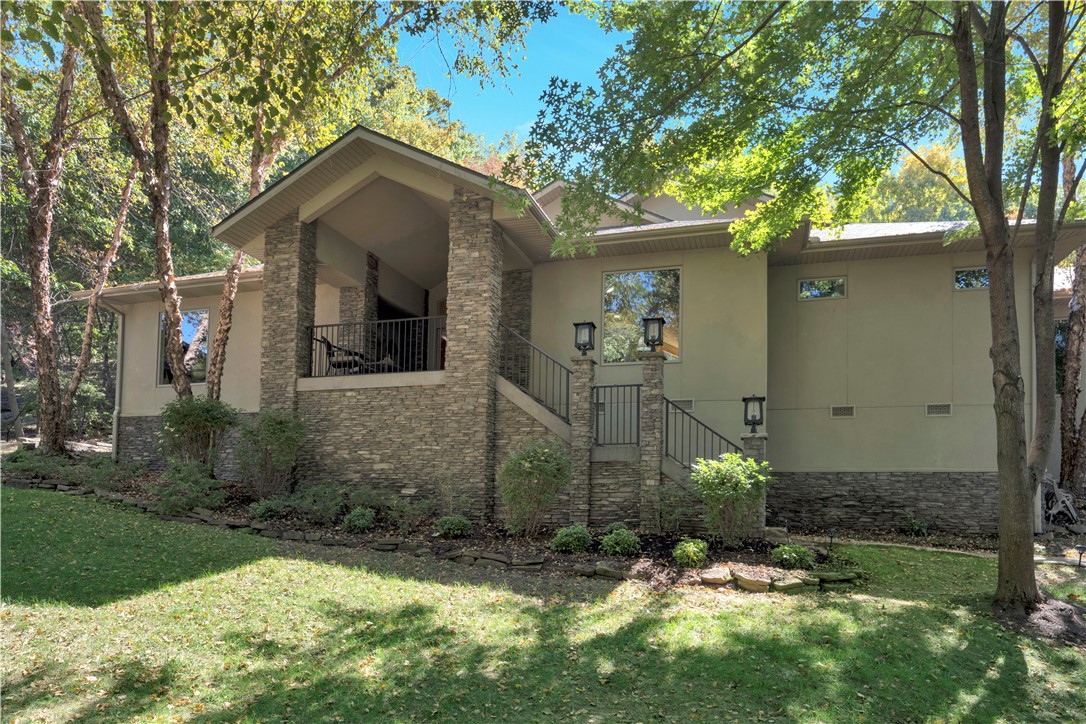 One of a kind, one owner, one level architecturally designed home in one of Fayetteville's 7 hillside communities.  While in the middle of town and sitting on 1.35 acres, the property is surrounded by mature trees, wildlife and only 5 minutes to UofA.  Beautifully designed home has an open floor plan, vaulted ceiling, wood flooring, and large windows with a view from the front & back.  For entertaining, the deck extends the entire back of house that leads to a private walking trail to UofA.  Don't miss this custom home in one of Fayetteville's most desirable neighborhoods.