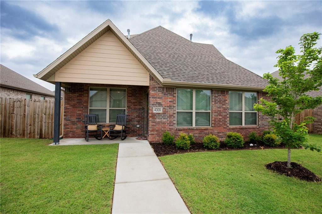 Move-in-Ready! Welcome home to West Bentonville! Alley-access 2 car garage, offering a neighborhood feel with convenient access to shopping, dining, schools, and recreation. 3 bedrooms, 2.5 baths, and 2,020 sq ft, this home features an open-concept layout centered around a large counter-height island overlooking a cozy gas fireplace with a cedar mantle and quartz tile surround. The kitchen boasts high-end 3cm granite countertops and a spacious pantry, while the dining area opens to a large patio perfect for outdoor entertaining. The main-level primary bedroom has an en-suite with a dual-sink vanity, custom tile shower, and large walk-in-closet. A convenient half bathroom serves guests downstairs. Upstairs, a versatile bonus room is ideal for a media room, office, or play area, along with two additional bedrooms and a full bath featuring matching upscale finishes. Luxury vinyl plank flooring runs through the main living areas, with ceramic tile in baths and plush carpet in bedrooms and the bonus room.