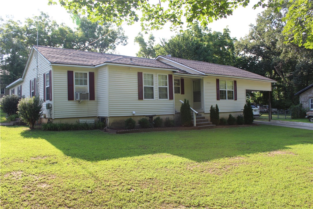 A lot of house for the money! Located in established neighborhood in Harrison, Arkansas.  Home has lots of options for configuration. 2060 sq. ft. 4 Bedrooms 2 and 1/2 bath but, a den/office could also be used as a bedroom and the large pantry could be used as a nursery for a large family.  Large detached workshop for the hobbyist or wood worker.  Well maintained landscaping and yard.
