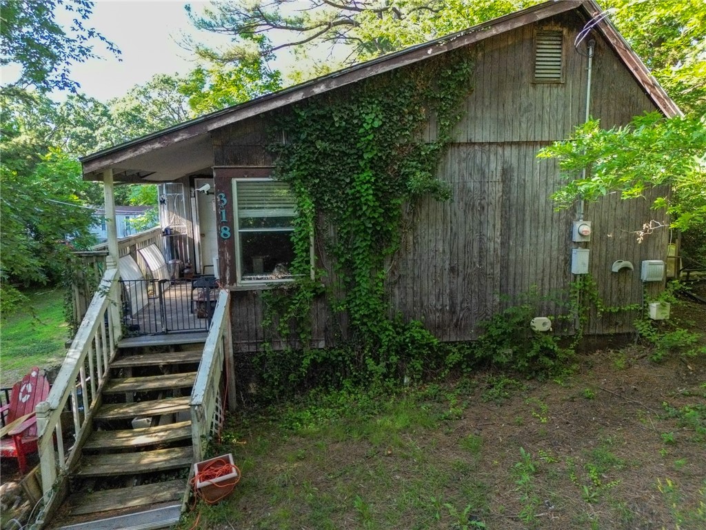 This one's all about the income potential. With an annual rental revenue from five older trailers this property is already performing.  The 1200 square foot house is occupied by the owners son, but the trailers are seeing great profit annually.  These structures are in rough shape and likely won't qualify for traditional financing, but for the right buyer, there's real upside here. This is one of 5 parcels available.  Check out MLS #'s 1311625, 1311609, 1311586, and 1311628 for more opportunities!  Whether you're looking for cash flow, land value, or a future redevelopment play, the numbers tell the story.