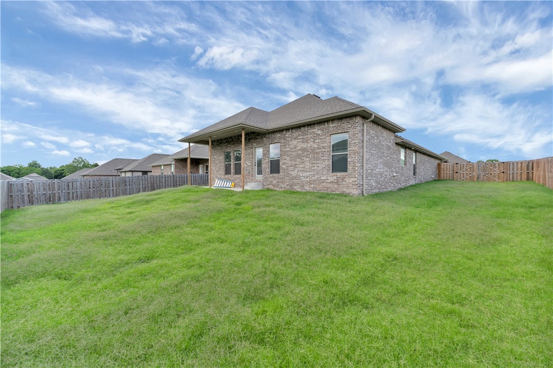 Welcome home to this well-maintained 3 bedroom, 2 bath brick home in an established Pea Ridge neighborhood! This one-level, 2,050 sq ft floor plan offers a smart split layout with double pantries, bar seating, and an open kitchen-to-living flow — perfect for everyday living and entertaining alike. The primary suite features a spacious bath with double vanities and direct access from the utility room to the closet. 10-foot ceilings in the entry, kitchen, living area, and primary bedroom add to the open, airy feel. Enjoy a large covered back patio and fully fenced yard, ideal for relaxing or hosting. Located just minutes from Pea Ridge schools, Pea Ridge City Park, and local shopping and dining, with an easy drive to Bentonville, Rogers, and the new Walmart campus. Don't miss this move-in ready home in one of NWA's fastest-growing communities!