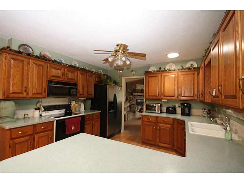 Fabulous location. Well Maintained home. Nice cabinets, large kitchen w/ breakfast nook. New Dishwasher. Living rm has vaulted ceiling w/new remote controlled gas log. Additional living space off living rm. Beautiful sun room (included in sq/ft) brings the outside in. All the bedrooms have nice closets. Full bath off the utility rm. Newer carpet, real wood floors & pergo. Trane heat pump with propane back up. New roof in 2012.(outbuilding has new roof too) New hot water heater. Anderson windows and doors.