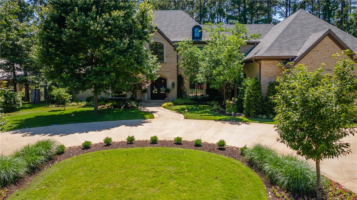 Stunning 6,835 SF golf-front home in Clear Creek, Fayetteville's premier gated golf community. This one-owner, custom-built residence features Brazilian teak hardwood floors, elegant molding, transom windows, interior shutters, an elevator, & beamed ceilings throughout. Designed for living & entertaining, the home offers a chef's kitchen with granite island, double ovens, gas cooktop, warming oven, butler's pantry, walk-in pantry, & abundant cabinetry. Amenities include a media room with projector, screen, theater seating & bar area, formal dining room, office, screened-in flagstone sunroom with fireplace, 2 laundry rooms, safe room, bonus room, huge walk-in storage room, and built-in generator. The main-level primary suite overlooks the golf course & features a spa-like bath. Outside, enjoy mature landscaping, a pond with two waterfalls, covered patios, balcony access, & golf course views. Featured in Citiscapes Magazine, this remarkable home must be seen to appreciate its design, character & amenities.