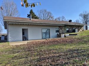 Beautiful country location for this berm home with 6.3 acres m/l, barn & a ton of potential.  Has both Hwy. 62/412 frontage & Hathcoat Road frontage that could easily be subdivided.  Seller will consider selling home with smaller acreage.  All #s are approx., age is estimate, square footage per assessor.