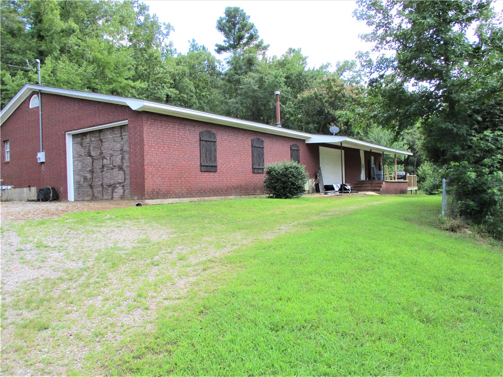 Tucked back into the woods on this beautiful wooded 13 acres you'll find this cute updated home with a large deck and covered front porch to enjoy your morning coffee, the deer and the great outdoors.  The 2BR/2BA home is decked out with so much new decor, you'll just have to see it!  For starters there's new paint, lighting, countertops, flooring and updated bathrooms plus an office, breakfast nook, pantry, lots of cabinets, split BR plan and spacious living room.  The guys will love the huge garage with plenty of room for storage and several vehicles. Must be preapproved to view the property.