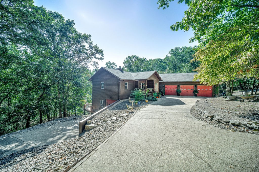 Wow! This is the one you have been waiting on!!  Lake front home tucked in a wide deep cove, it has all the things! Superb lake appeal from the time you drive onto a private 8.4 acre wooded lot. From the living room experience soaring vaulted ceilings, wide plank oak hardwood floors, updated kitchen, and lots of windows to enjoy the views Beaver Lake. There are lakeside decks on both the main level and basement level. Two en-suite master bedrooms on the main level, and downstairs you will find the third and fourth bedrooms, family room, kitchen, and loads of storage.  Private 1 slip (10x24) dock at the shoreline. Located at the north end of Beaver Lake, known for the jumping rock, and beautiful water clarity.