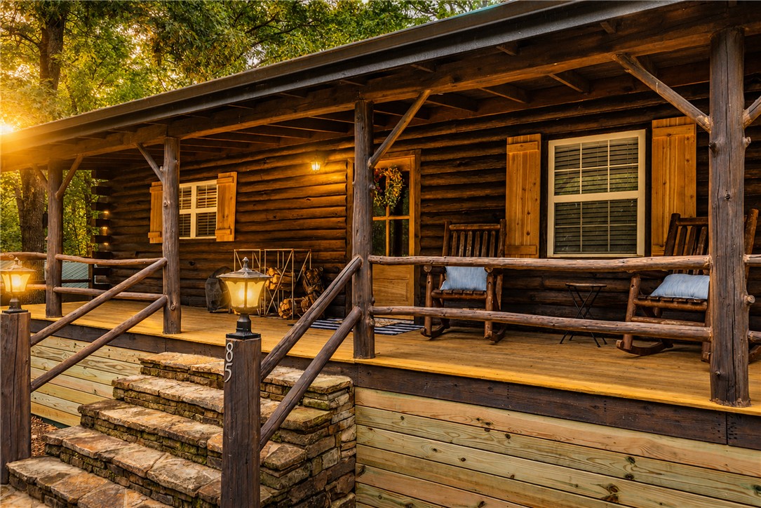True Ozark living in a real log home that comes with a boat slip & lift on Beaver Lake. This spacious home has had many recent upgrades and improvements such as new flooring, new lighting, new paint, new bathroom vanities, new blinds, new water heater, logs have been resealed, new front door, new interior doors, porch decking stained with new under pinning. Two full length covered back porches overlooking the peaceful valley and a full length covered front porch gives you choices to enjoy the serenity and peace that comes with nature. The easy access to the boat dock allows for a great day on the lake while the spacious home allows for entertaining or to rest comfortably after a long day. This home is versatile and would serve as a wonderful vacation home or that permanent home to escape the city.