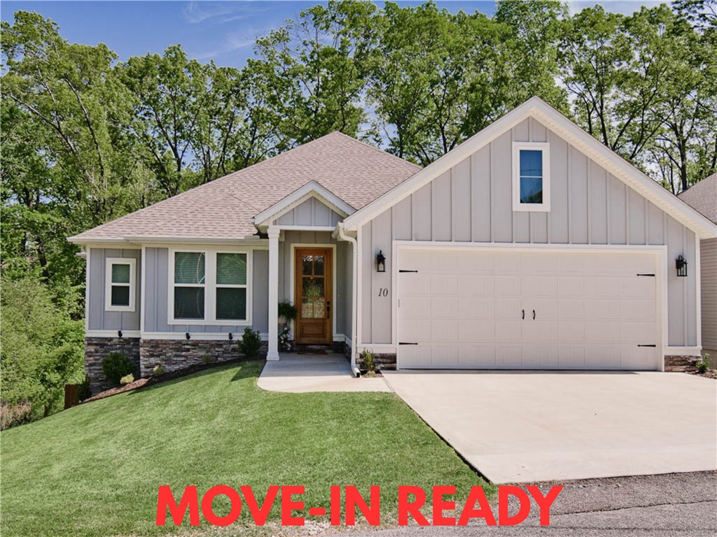 Welcome to this impeccably maintained home built in 2023, offering breathtaking wooded views! Sewer lot! Situated just down the street from the Uphill Both Ways Trail Crossing and within very close proximity to Lake Windsor, Lake Avalon, Tanyard Creek, and the OZ Bike Lift. Step inside to discover beautiful hardwood floors throughout, including in the primary bedroom and guest bedroom / office. The primary bath boasts a soaking tub, a spacious custom tile shower, and an expansive closet for all your storage needs. 3 bathrooms! Enjoy the grandeur of cathedral ceilings in the living and beautiful custom cabinets in the kitchen, complete with a large pantry. Laundry room is massive and features tons of cabinets and a sink. The home is adorned with custom finishes throughout, enhancing its appeal. Relax on the huge covered patio with a wood ceiling or utilize the extensive storage space below the home. The fenced-in backyard offers plenty of space for outdoor activities. Bentonville schools!