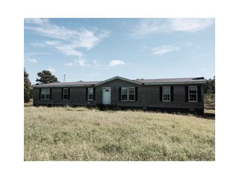 FOR A LONG TIME NOW, YOU'VE WANTED THAT PERFECT PLACE IN A RURAL SETTING, WITH A LARGE HOUSE, CLOSE TO PAVED ROADS, WITH A FLAT YARD - GUESS WHAT? YOU JUST FOUND IT! THIS MODULAR IS HUGE! IT HAS A DEN AND LIVING RM, DINING, 4 TO 5 BEDROOMS, AND A LARGE,MASTER BEDROOM AND MASTER BATHROOM. THIS FORECLOSURE IS SOLD AS-IS, WHERE-IS, WITH NO DISCLOSURES, AND NO REPRESENTATIONS OF ACTUALITY, BUYER WILL BE RESPONSIBLE FOR SATISFYING ANY AND ALL CONCERNS PRIOR TO PURCHASING. CORP. ADDS. WILL APPLY. PRETTY HOME!
