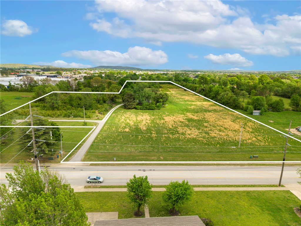 Prime development opportunity featuring three contiguous parcels totaling 12.84 acres, zoned O-1 Neighborhood Office District. This flexible zoning allows for a wide range of potential uses including townhomes, duplexes, single-family housing development, professional office space, and healthcare clinics—making it an ideal investment. The property features predominantly level, open terrain with development-friendly topography, providing highly usable acreage and favorable site conditions for a variety of residential, office, medical, or mixed-use projects. Conveniently located just 3.6 miles from I-49, the site offers excellent access to the broader Northwest Arkansas market. Multiple structures currently exist on the property, including two residential homes; however, the true value lies in the land and its exceptional development potential. Also listed as commercial property; see MLS #1342839.