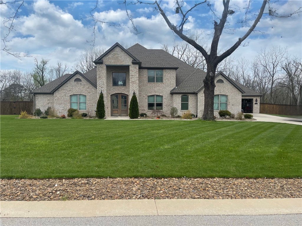 Nestled in the serene Copper Ridge subdivision of Little Flock, Arkansas, this stunning 4,500 sq ft home offers a blend of luxury and comfort. Situated on a spacious 1.06-acre lot, the property boasts 4 bedrooms, 4.5 baths, and exquisite custom trim work throughout. The open-concept living areas feature vaulted ceilings, LED lighting, and large windows that fill the space with natural light. The gourmet kitchen is equipped with modern appliances, granite countertops, and ample storage.The master suite offers a private retreat with an en-suite bath, complete with high-end finishes. The beautifully landscaped front and back yards feature an irrigation system for easy maintenance, while the fenced backyard provides privacy and space for outdoor activities. A screened-in patio with a cozy fireplace is ideal for year-round entertaining. The 4-car insulated garage provides ample parking and storage. This home truly captures the essence of modern living in a quiet, desirable neighborhood.