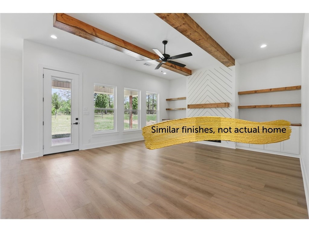 Picture this, a new construction home with a couple of acres, just out of the city life and it is conveniently located about ten minutes to Prairie Grove schools. Finishes include LVP flooring, quartz counters, and more. This exquisite home features quality finishes and attention to detail wrapped up in a well-designed split floor plan, bonus room for your office or homework space and a big covered porch to enjoy the views all while relishing the peace and quiet of your rural setting. The area surrounding the house is cleared and level, providing ample space for outdoor activities, gardening, or simply enjoying the fresh air. Meanwhile, the remaining wooded areas invite exploration and adventure, creating a delightful natural playground right in your backyard. Hurry by now while you can make this house truly your own with choices still available on paint, counters, floor colors and more. Taxes based on the vacant lot and will change. New parcel #tbd.