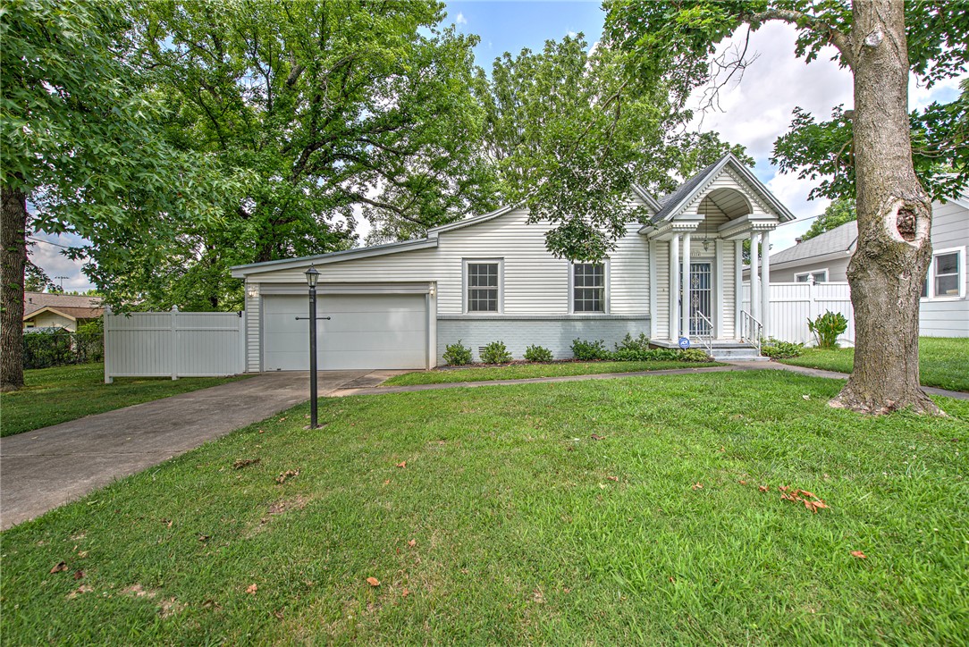Steeped in history and filled with character, this charming 1921 home has been lovingly cared for by four generations of the same family. Situated on an oversized lot stretching from 4th Street to 5th Street in Downtown Rogers, this unique property offers a rare opportunity to own a piece of the city's past while enjoying the convenience of an exceptional location close to shopping, dining, parks, and entertainment. Inside, you'll find timeless features including plaster walls paired with durable and updated luxury vinyl plank flooring and updated plumbing (no clay pipes), newer HVAC, water heater and roof for added peace of mind. Outside, the expansive lot provides endless possibilities and includes a dedicated workroom, abundant storage, and a detached outbuilding. Whether you're drawn to the craftsmanship of historic homes or looking for a property with space, character, and potential in the heart of Rogers, this one is ready for its next chapter.