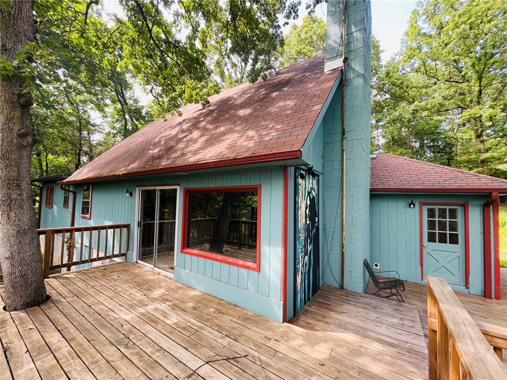 Check out this 5BR, 2BA, home on 2.3 acres located just outside Berryville city limits and within 250 feet of the Osage Creek.  Paved road takes you within 2/10 of a mile to this property with end of the road privacy with only 2 neighbors past it.  Home could use some updating but has a newer septic system, wood deck, gutters, & HVAC installed in 2020.  There is a 10x20 green house, 10x16 storage shed, and well house. The Kitchen, Dinning, and Living area is a large open space with 3BR's, 2BA on main level and 2 more BR's upstairs. Large windows overlook the view to the South.  Come enjoy the peace and quiet of country life only minutes from town.  Home is to sell as-is.