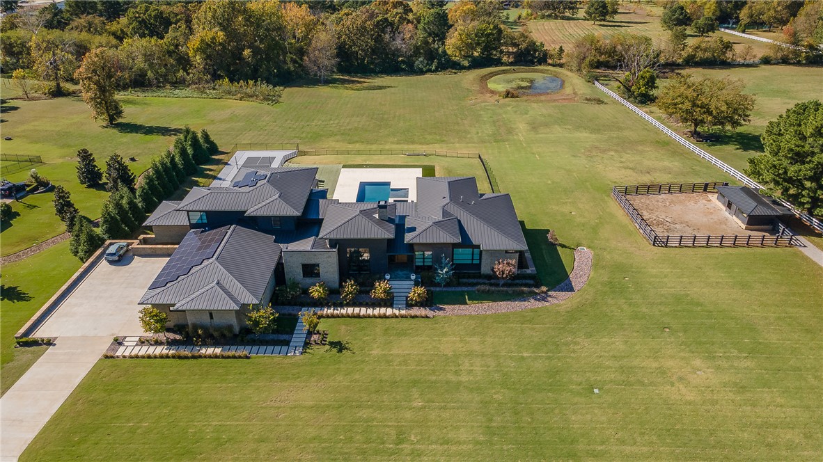 This stunning custom-built estate in East Fayetteville offers a rare chance to own a like-new home without the wait. Meticulously maintained & move-in ready, it sits on 5 serene acres with a private pond. The 13,000+ sq ft residence features 5 bedrooms, 5 full baths, and 1 half bath. Exceptional craftsmanship is evident in white oak floors, marble finishes, soaring ceilings, & abundant natural light. The chef’s kitchen includes a Lacanche range, triple dishwashers, & premium appliances, opening to a grand living area with retractable glass doors for seamless indoor-outdoor living. Highlights include a two-story office, luxurious primary suite with screened porch & yoga room, plus a den, solarium, theater, & basement bar. Outdoor features include a beach-entry pool, fire pit, pickleball court, & heated patios. A 6-car garage offers an EV charger, car lift, & wash bay. Solar power completes this private luxury.  Recently sold & never occupied due to an unexpected relocation. www.4631ebridgewaterln.com