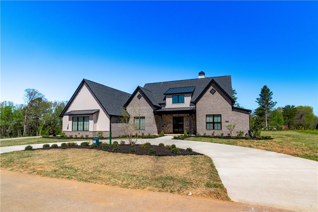 Beautiful new construction in brand new 4 lots subdivision in East Fayetteville. This 5 bedroom or 4 bedroom with large bonus room and bathroom upstairs is spacious with wide open spaces downstairs great for entertaining.  Split floor plan with a large pantry, upgraded Frigidaire Pro series appliances, a large master suite, bathroom and closet, 3 car side loading garage, large back patio and beautiful front entry.