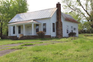 If you are looking for country home with a huge concrete floored shop, a nice horse or cow barn and 3.5 acres, you have found your piece of paradise! A comfortable home, clean and sturdy with a metal roof. Big remodeled kitchen, huge living with exposed beamed ceiling, and wood burning stove, with central heat and air! Separate dining, two or three bedroom, one bath. Big rock covered porch