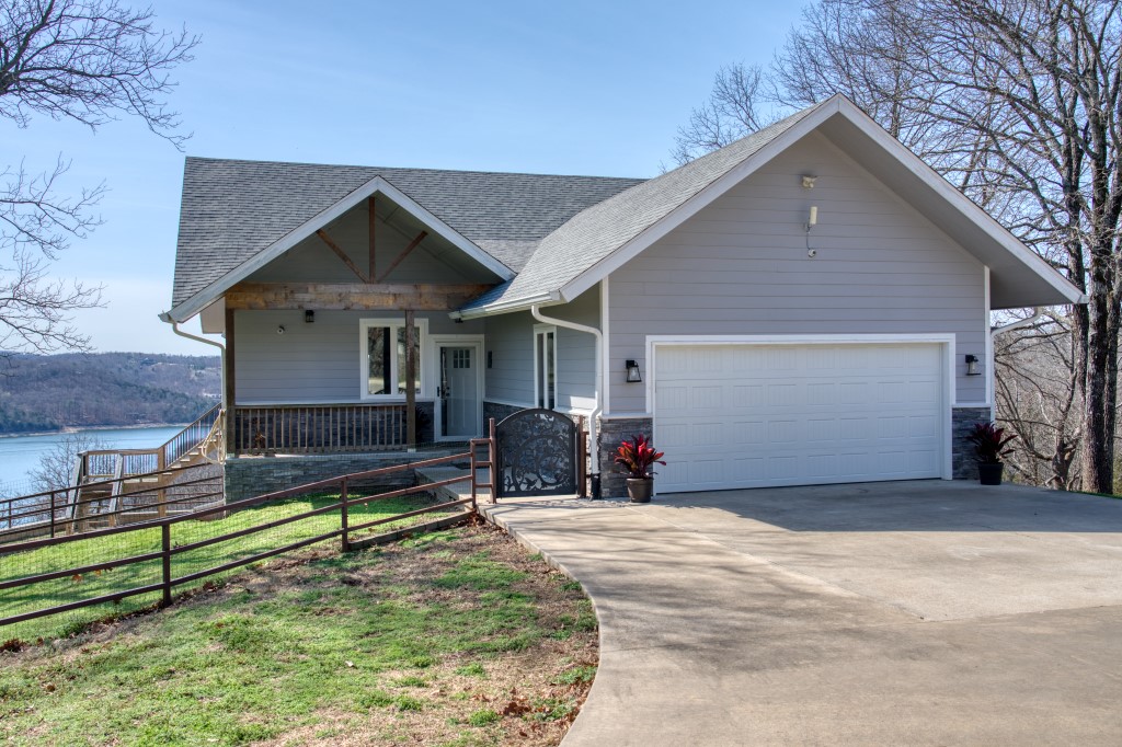 Open the gate and follow the 1000’ long concrete driveway onto your private 15+ acre ridgetop overlooking Beaver Lake! Live comfortably in this amazing 3 bed/2 bath, 2178 square foot main home and use the cozy 2 bed/1 bath, 1224 square foot guest house for friends, family, or as a game room, studio or workshop! Wake up to the lake view from both houses and enjoy the gorgeous sunrise and sunset on the large decks! This property features a private well and whole-house water filtration system, security system, Tesla car chargers in both garages, and your pets will enjoy the large fenced yard and dog kennel! This rare, flat ridgetop offers additional land to build on, and it’s location on paved roads and close to Beaver Dam, the White River, and Starkey Marina makes this property one that you will want to keep in your family for generations!