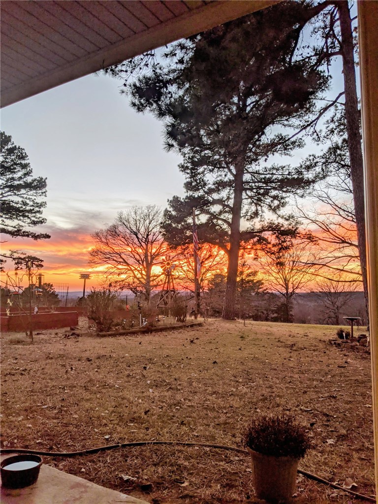 Magnificent, cross-fenced 98.15 acres boasting a 2279 sq ft 3-bed/2-bath well-maintained home featuring a natural stone wood-burning fireplace, eat-in kitchen and plenty of storage throughout. 5 outbuildings-greenhouse/garden shed/tool shed/workshop/metal barn-all on a separate electric meter from the house. Abundant caves, springs, creeks, 3 well-stocked ponds, koi pond and beautiful gardens created by a Master Gardener. 50+/- acres is manicured, almost park-like, and 48+/- acres are wooded with trails large enough for a 4-wheeler.  Situated on the highest point on Lancaster Rd, the long-distance views and sunsets are phenomenal and can be viewed from the covered back porch while also enjoying the abundant wildlife. If you love the outdoors, this is the place for you. This is a remarkably beautiful and meticulously maintained property, don't miss this opportunity to own a piece of Ozark heaven! Property like this doesn't come along very often.  New photos coming soon.
