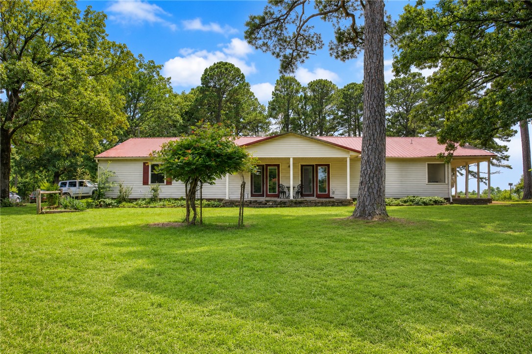 Magnificent, cross-fenced 98.15 acres boasting a 2279 sq ft 3-bed/2-bath well-maintained home featuring a natural stone wood-burning fireplace, eat-in kitchen and plenty of storage throughout. 5 outbuildings-greenhouse/garden shed/tool shed/workshop/metal barn-all on a separate electric meter from the house. Abundant caves, springs, creeks, 3 well-stocked ponds, koi pond and beautiful gardens created by a Master Gardener. 50+/- acres is manicured, almost park-like, and 48+/- acres are wooded with trails large enough for a 4-wheeler.  Situated on the highest point on Lancaster Rd, the long-distance views and sunsets are phenomenal and can be viewed from the covered back porch while also enjoying the abundant wildlife. If you love the outdoors, this is the place for you. This is a remarkably beautiful and meticulously maintained property, don't miss this opportunity to own a piece of Ozark heaven! Property like this doesn't come along very often.