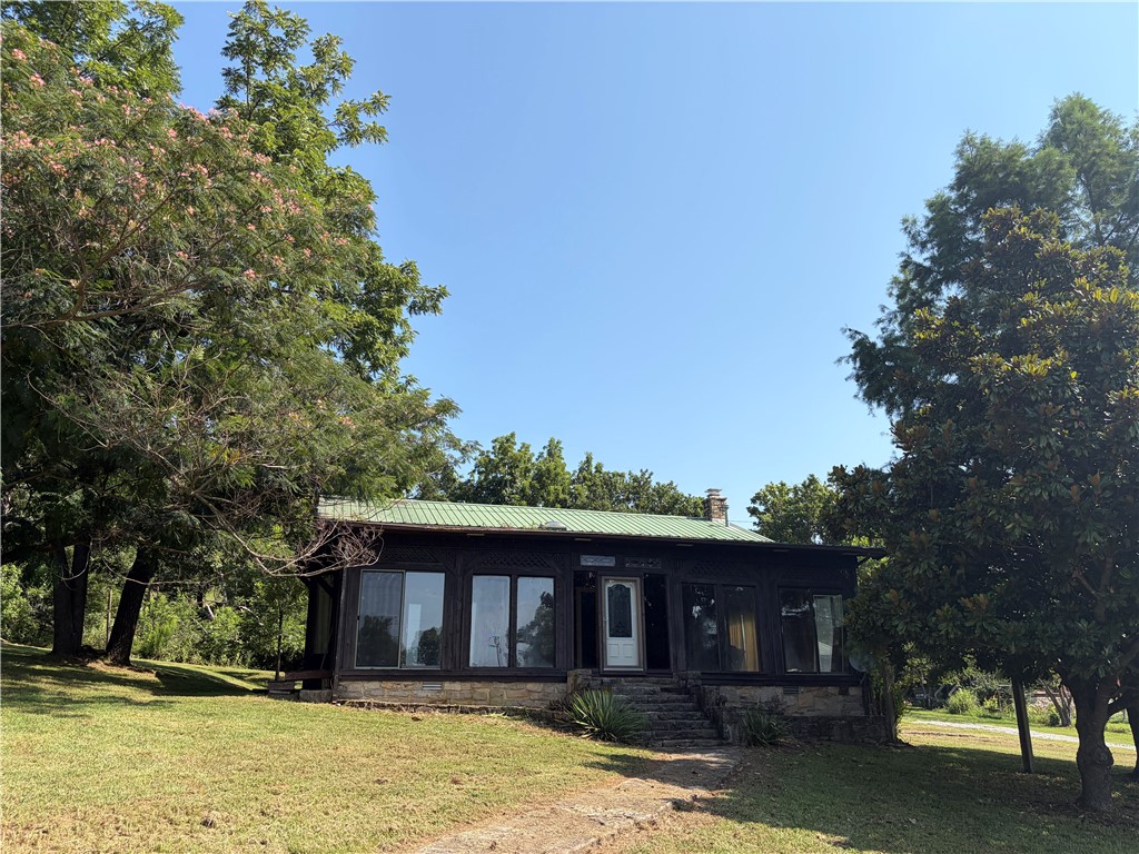 Comfortable home just minutes from beautiful Bull Shoals lake.  Home features nice wood beam ceilings, wood burning fireplace, wet bar and all appliances stay including the Jenn Aire range.  Property also has a second outbuilding that is 384 sq ft (16x24).  The backyard could be great for entertaining with a little TLC on existing custom grill and water feature.  Bring your boats and jets skis and enjoy the lake that are only 10 minutes away.  This property is priced to move at only $159,000!!!!