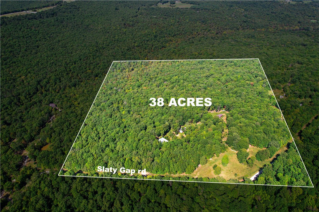 Discover the possibilities on this exceptional 38-acre property only minutes from downtown Fayetteville. This scenic property is ideal for hunting, recreation, and outdoor living, featuring abundant wildlife, wooded acreage, a private pond and wet weather creeks. These beautiful acres includes a cabin with water, internet and electricity and a fully insulated barn. With existing utilities, this property is hard to beat. Whether you're seeking a weekend retreat, recreational getaway, or a site to build your dream home, this land offers privacy, versatility and natural beauty. Enjoy a peaceful rural setting with convenient access to Fayetteville, West Fork or major commuter routes. A rare opportunity to own a turn-key recreational property in Northwest Arkansas.