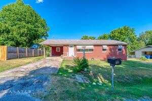 This charming home is located within minutes of Hospital & Downtown Square, and on a dead end street. Features 4 bedrooms, 1&1/2 bath, 2 livingrooms, kitchen with beautiful custom made cabinets, attached carport, fenced backyard with a cute shed, and a large deck