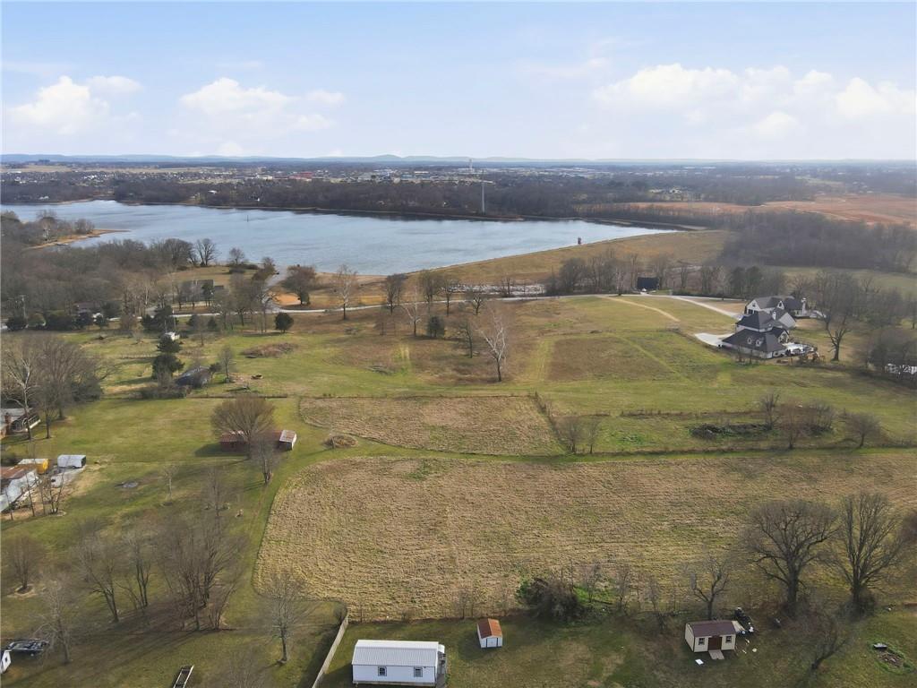 Rare opportunity in Elm Springs-5 scenic acres with open views of Elmdale Lake. Gently rolling and picturesque, this property is ideal for a private luxury estate or a builder's showcase project. Peaceful setting with endless potential.