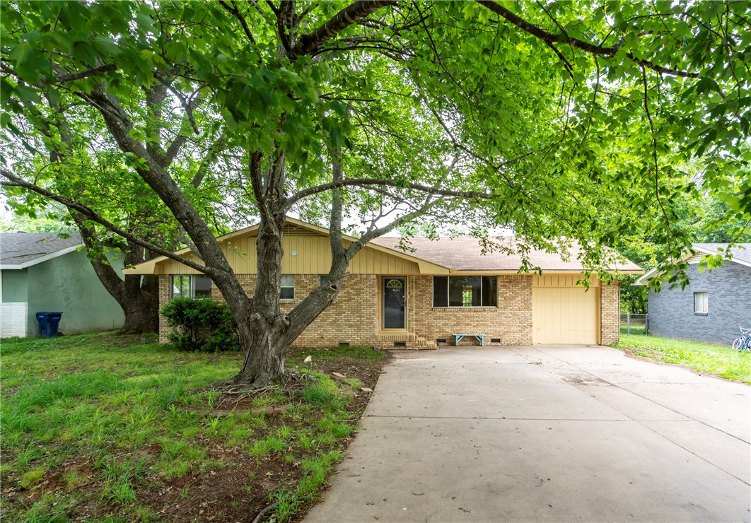 Presenting an exceptional opportunity at 215 W Highland ST, Siloam Springs, Arkansas, this single-family residence, constructed in 1974, offers a move-in ready and inviting home experience. One of the bathrooms features a walk-in shower, providing both convenience and an updated contemporary aesthetic. A primary bedroom offers the luxury of an ensuite bathroom, a spacious closet, and the warmth of hardwood flooring, creating a private retreat within the home. Newer stackable washer/dryer, dishwasher and refrigerator convey. Complementing the interior, the property boasts a large private yard for outdoor enjoyment, an attached garage for convenience, and both a patio and a covered patio, expanding the living space outdoors. Large carport in backyard provides protecting cover for lawn equipment/recreation vehicles/toys. This ranch-style residence presents a compelling blend of comfort and functionality, poised to accommodate a discerning new owner.